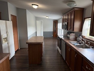 479 Cal Durham Road Bethpage, TN 37022 - Photo 9 of 19 a kitchen with stainless steel appliances granite countertop a refrigerator a sink dishwasher a stove and a dining table with wooden floor