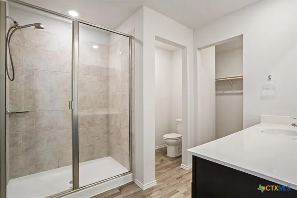 a bathroom with a shower a toilet and a sink