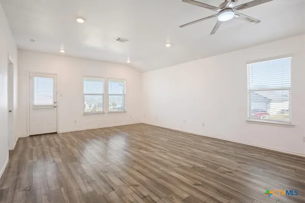 wooden floor in an empty room with a window