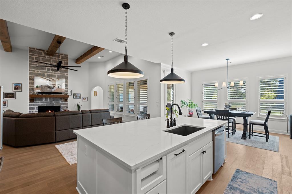 2012 Southern Rise Court Granbury, TX 76049 - Photo 12 of 40 a kitchen with stainless steel appliances a sink a counter top space cabinets and wooden floor