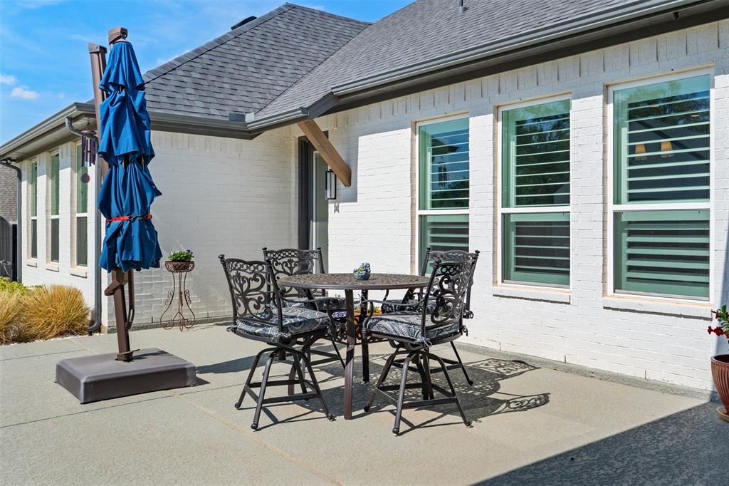 2012 Southern Rise Court Granbury, TX 76049 - Photo 29 of 40 a patio with table and chairs and potted plants