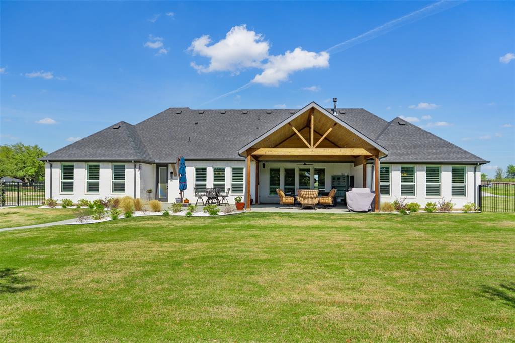 2012 Southern Rise Court Granbury, TX 76049 - Photo 30 of 40 a front view of a house with swimming pool having outdoor seating