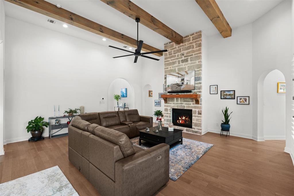 2012 Southern Rise Court Granbury, TX 76049 - Photo 6 of 40 a living room with furniture a fireplace and a flat screen tv