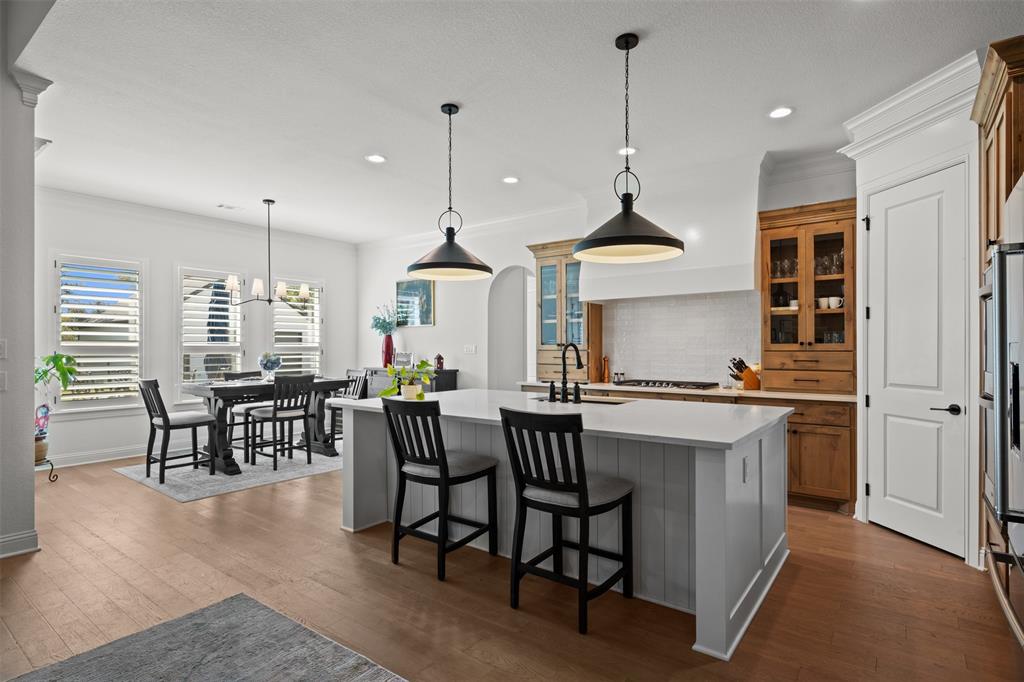 2012 Southern Rise Court Granbury, TX 76049 - Photo 10 of 40 a kitchen with stainless steel appliances granite countertop a stove a sink a dining table and chairs