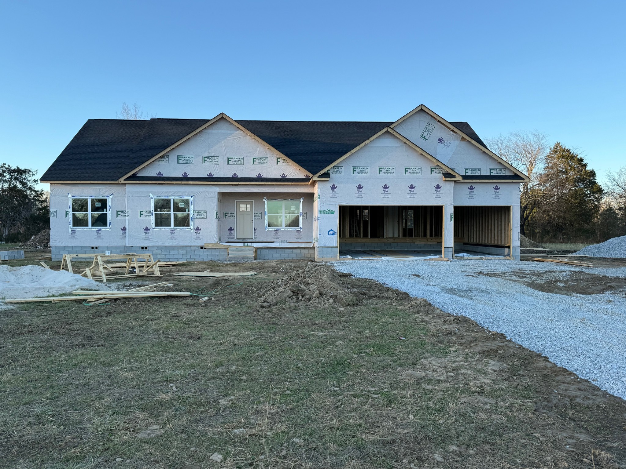 a view of a house with a yard and large tree