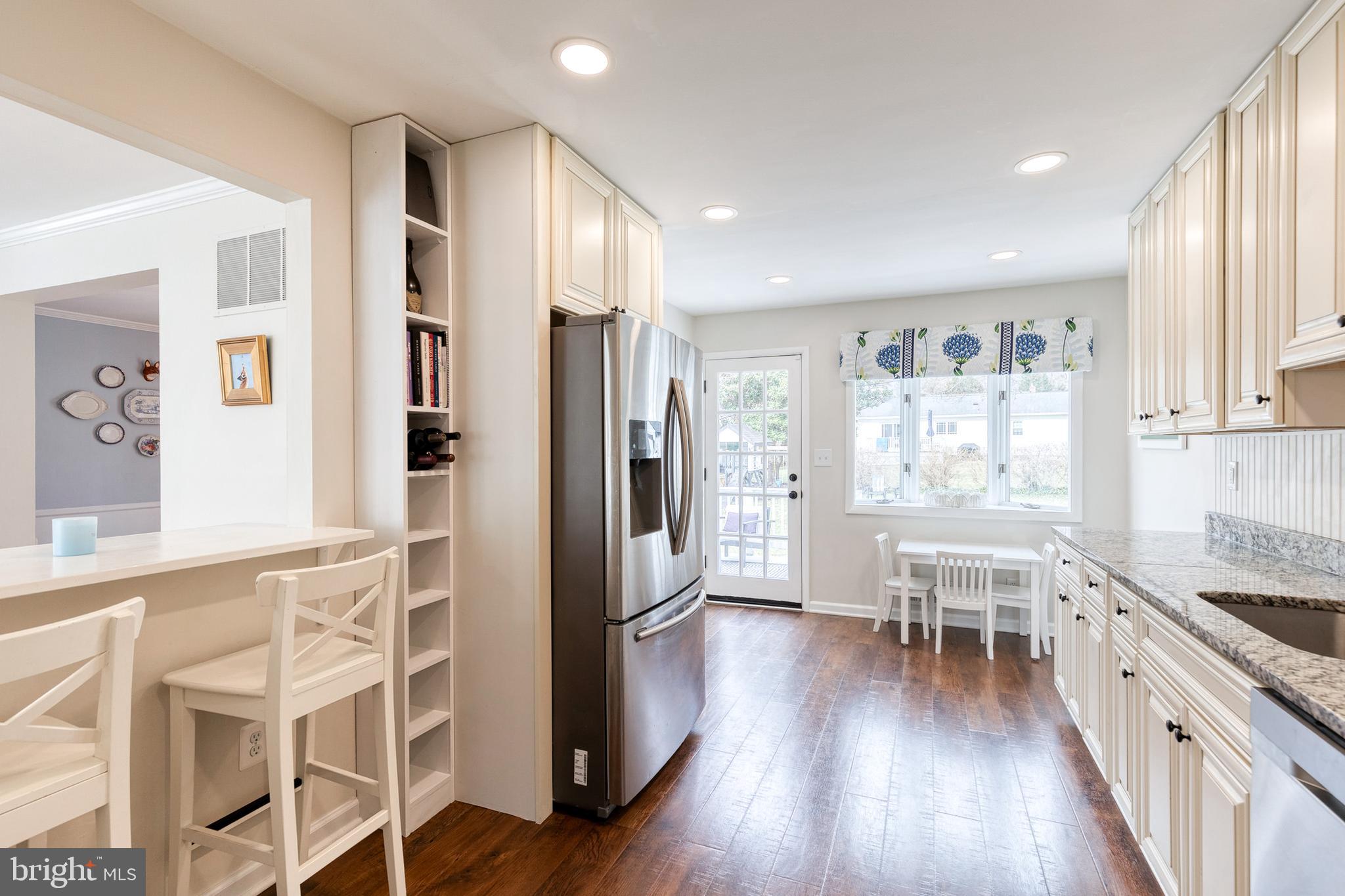 8206 Burnley Road Towson, MD 21204 - Photo 11 of 37 a kitchen with stainless steel appliances a refrigerator and wooden floor