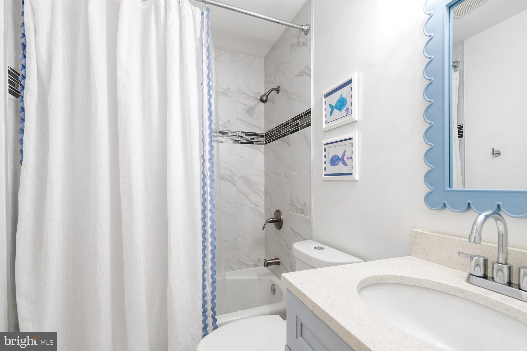 8206 Burnley Road Towson, MD 21204 - Photo 22 of 37 a bathroom with a sink a toilet and shower curtain