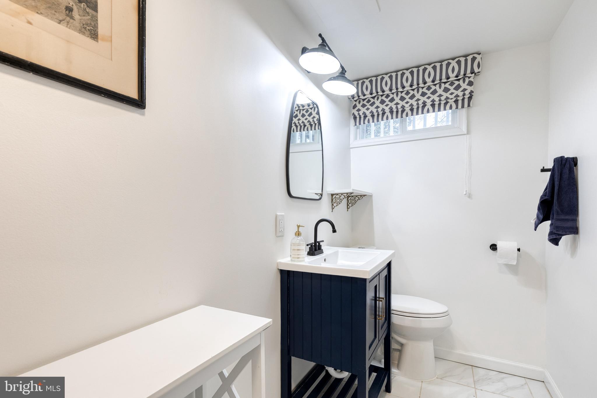 8206 Burnley Road Towson, MD 21204 - Photo 29 of 37 a bathroom with a sink toilet and shower