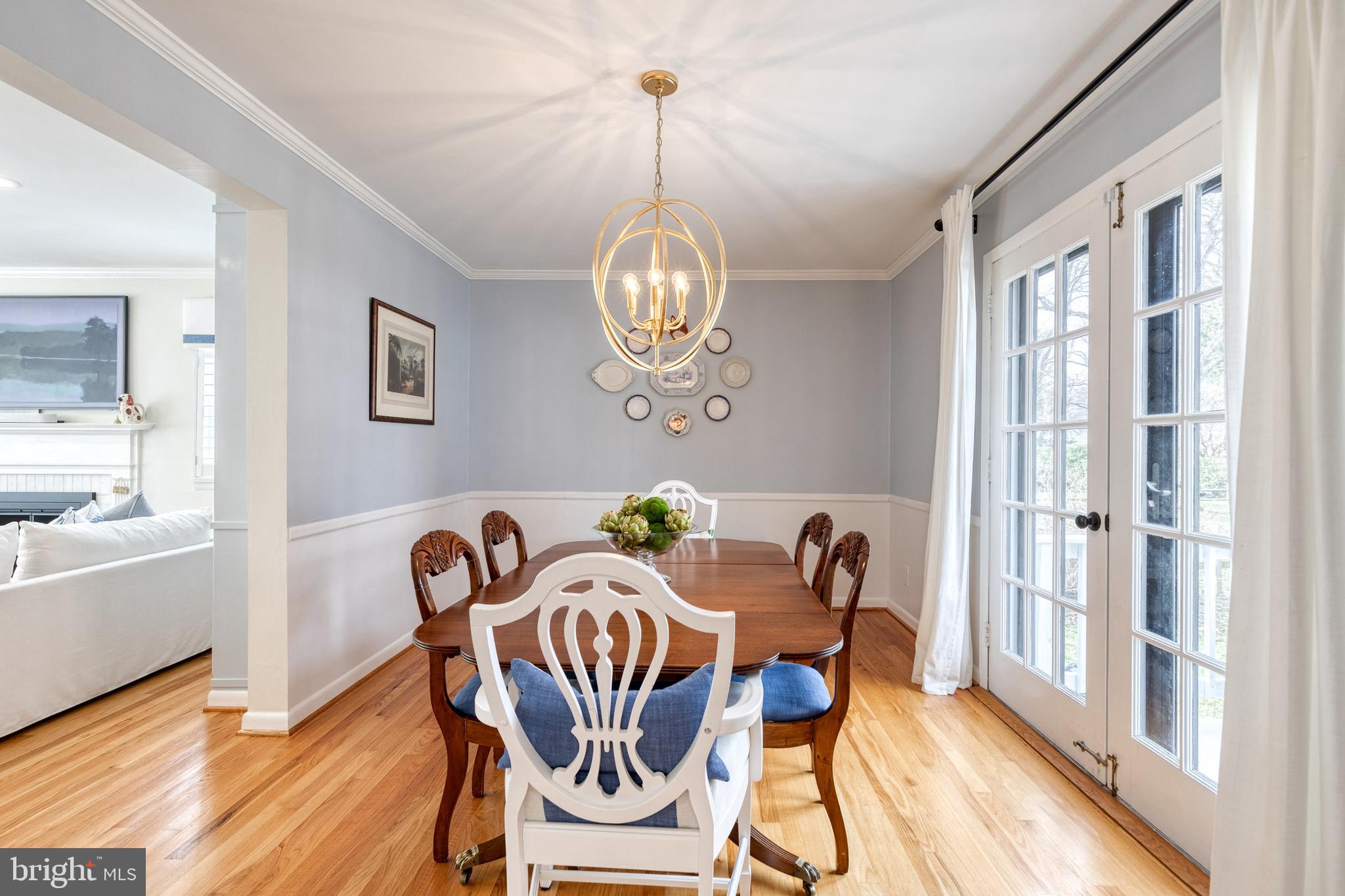8206 Burnley Road Towson, MD 21204 - Photo 10 of 37 a view of a dining room with furniture wooden floor and a chandelier