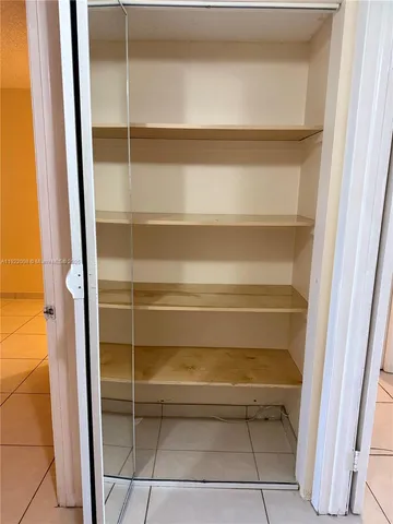 a view of empty room with white walls