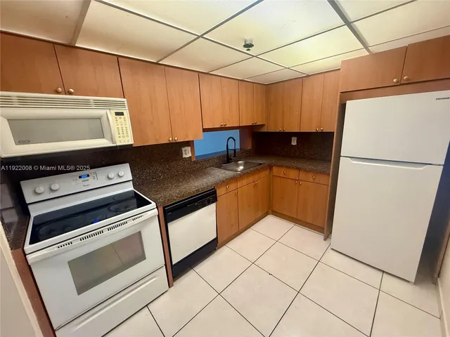 a kitchen with a stove a sink and a refrigerator