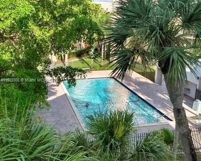 a front view of a house with a yard and potted plants