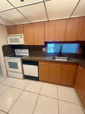 a kitchen with cabinets and appliances