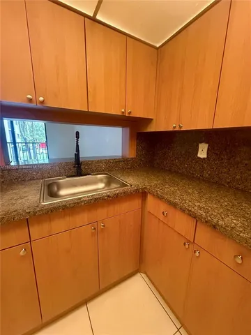 a kitchen with stainless steel appliances granite countertop a sink