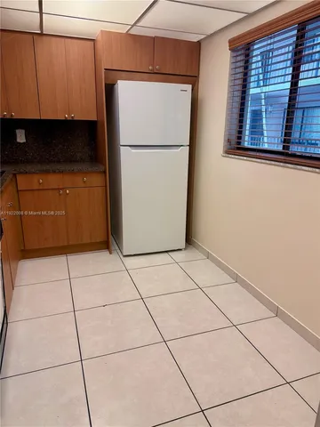 a white refrigerator freezer and a counter in a kitchen