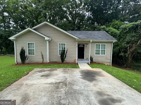 a front view of house with yard and green space