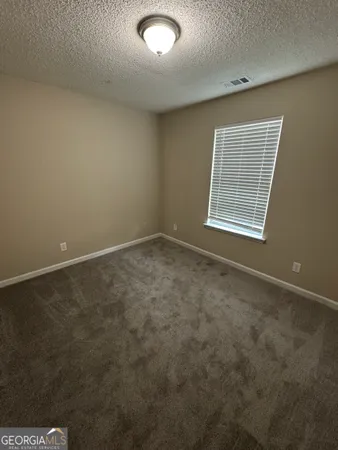 an empty room with a empty space and windows