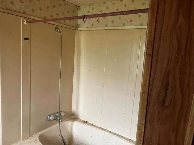 a bathroom with a shower and a tub