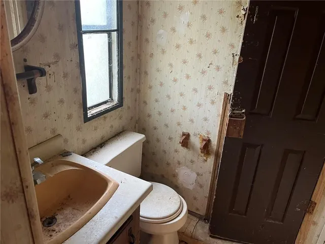 a bathroom with a toilet and a sink