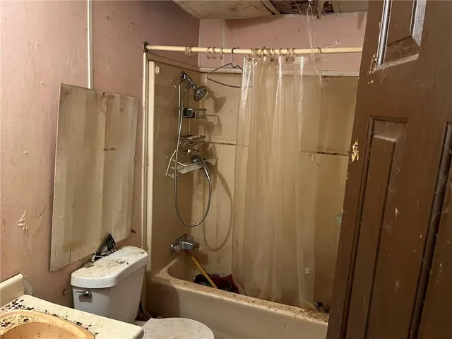 a bathroom with a sink mirror toilet and shower