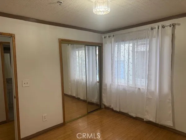 a view of a room with wooden floor