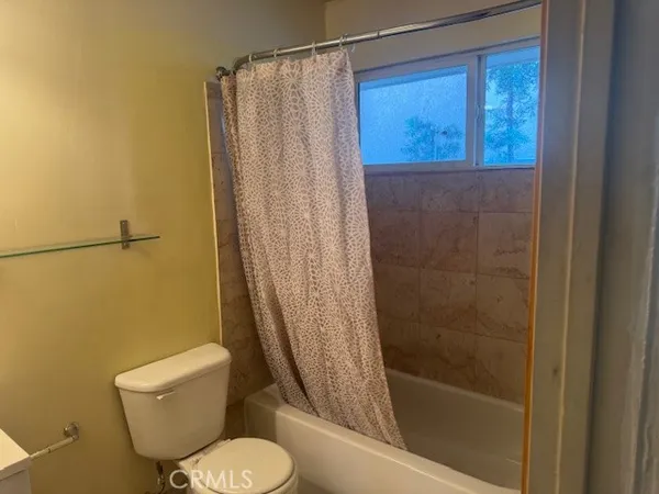 a bathroom with a shower and a toilet