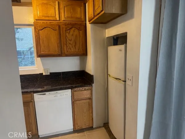 a kitchen with a refrigerator and a sink