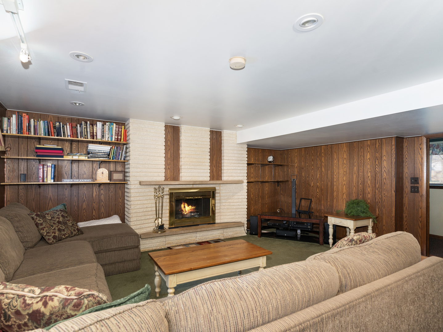 10S144 Ridge Road Naperville, IL 60565 - Photo 15 of 28 a living room with furniture a fireplace and a book shelf