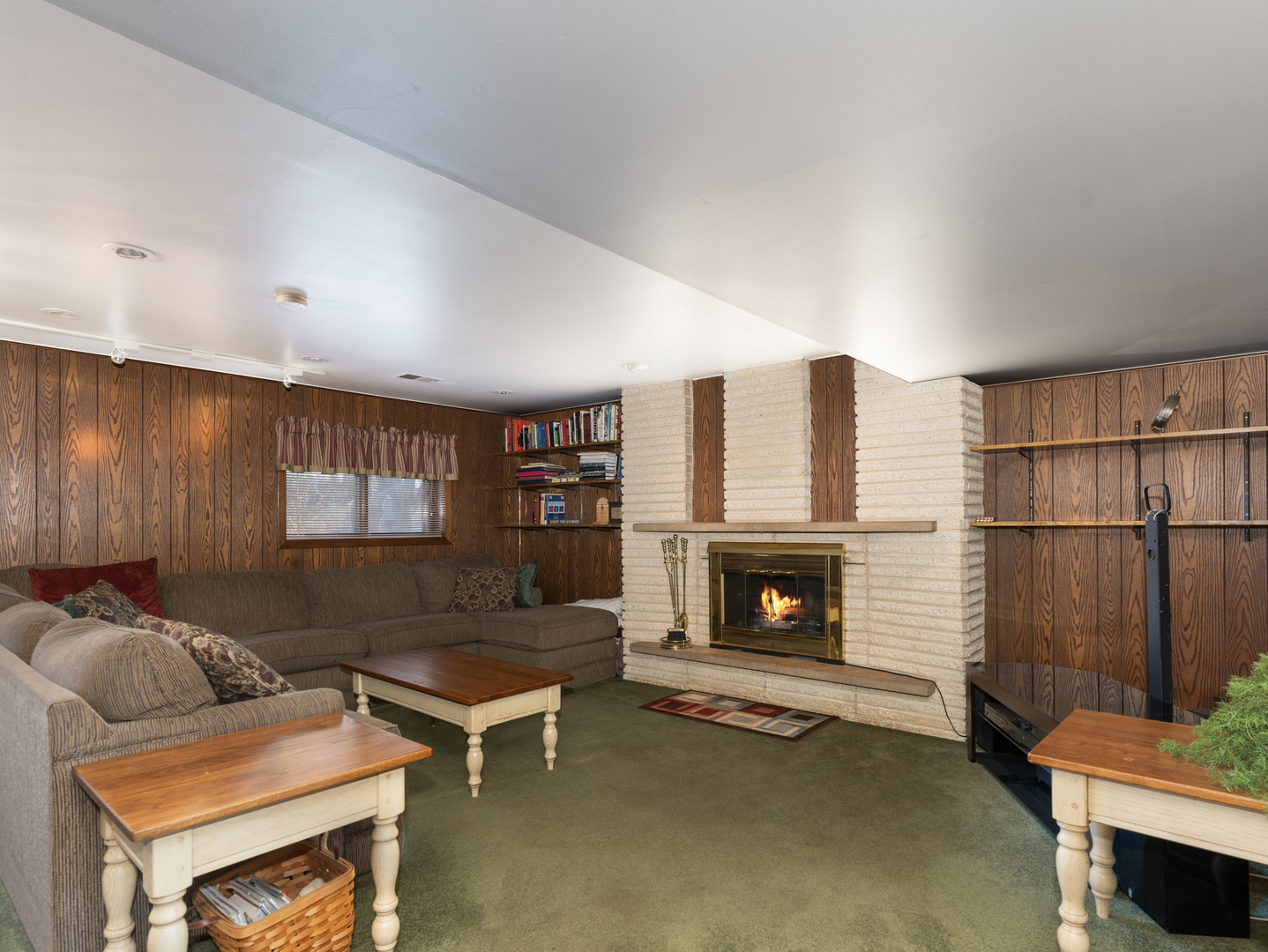 10S144 Ridge Road Naperville, IL 60565 - Photo 16 of 28 a living room with furniture a fireplace and a flat screen tv