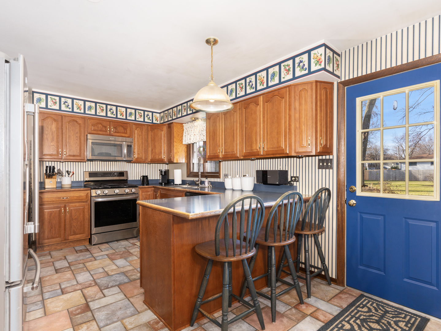 10S144 Ridge Road Naperville, IL 60565 - Photo 7 of 28 a kitchen with stainless steel appliances granite countertop a stove top oven a sink dishwasher and a dining table with wooden cabinet