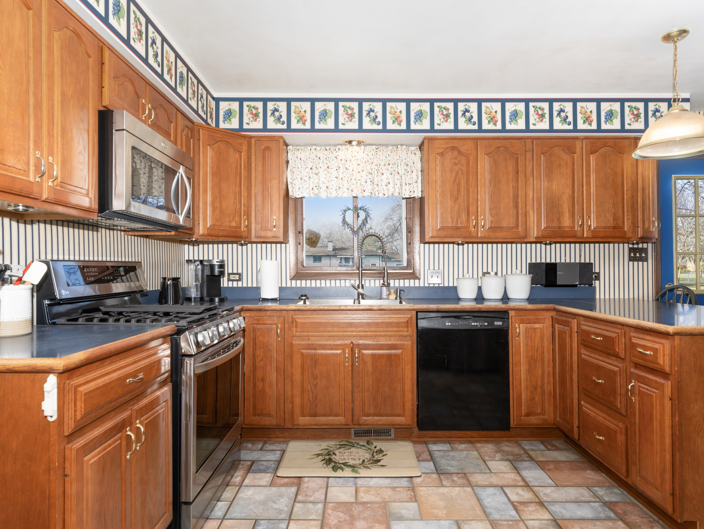 10S144 Ridge Road Naperville, IL 60565 - Photo 9 of 28 a kitchen with a sink stove and cabinets