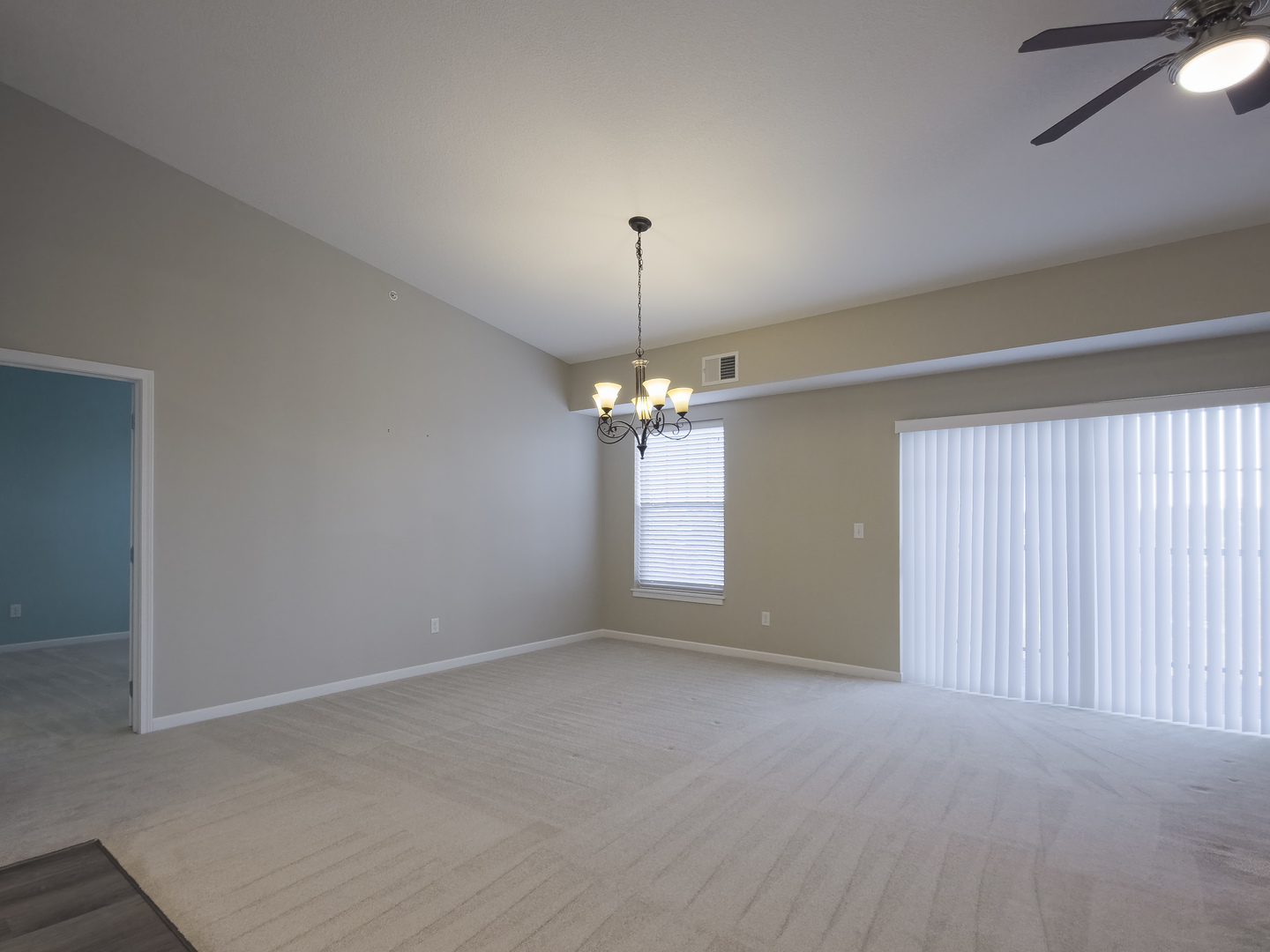2592 Middle Road, Unit 313 Bettendorf, IA 52722 - Photo 18 of 52 en empty room with windows and chandelier