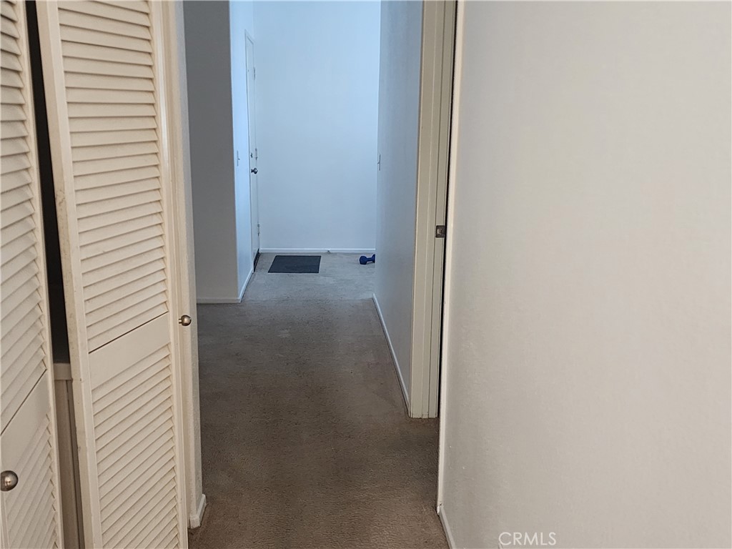 28455 Red Apple Road Menifee, CA 92585 - Photo 7 of 15 a view of a hallway with a white door