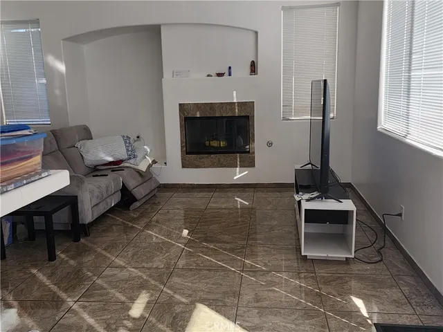 a living room with furniture a window and a fireplace