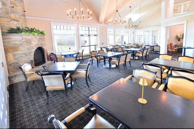 a dining room with furniture and a window