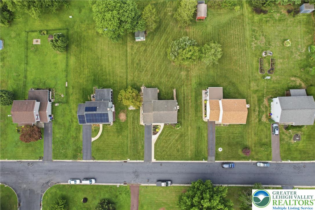 1385 Woodmere Road Pottstown, PA 19464 - Photo 51 of 57 An aerial perspective reveals a quiet neighborhood with well-maintained homes, green yards, and solar panels.