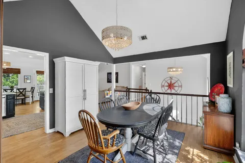 a view of a dining room with furniture and a chandelier