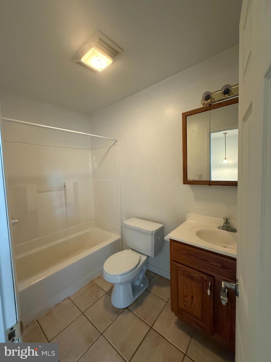 1123 Almond Road, Unit 2 Pittsgrove, NJ 08318 - Photo 6 of 9 a bathroom with a sink a toilet and shower