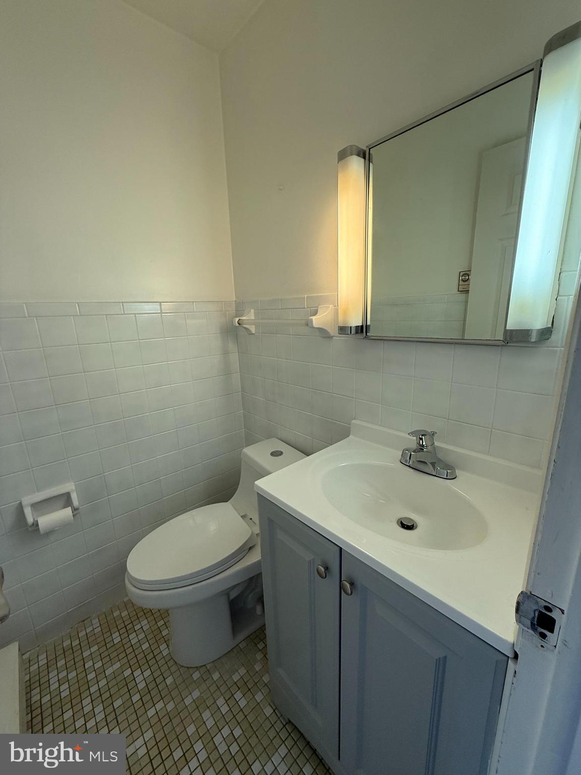 1123 Almond Road, Unit 2 Pittsgrove, NJ 08318 - Photo 7 of 9 a bathroom with a sink a toilet and mirror