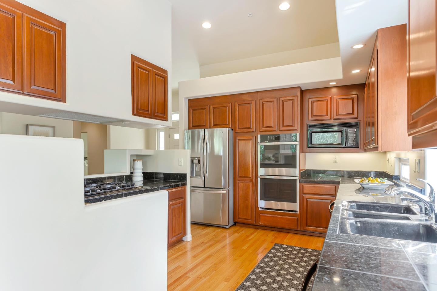 3120 Middle Ranch Road Pebble Beach, CA 93953 - Photo 13 of 39 a kitchen with stainless steel appliances granite countertop a refrigerator and a stove top oven