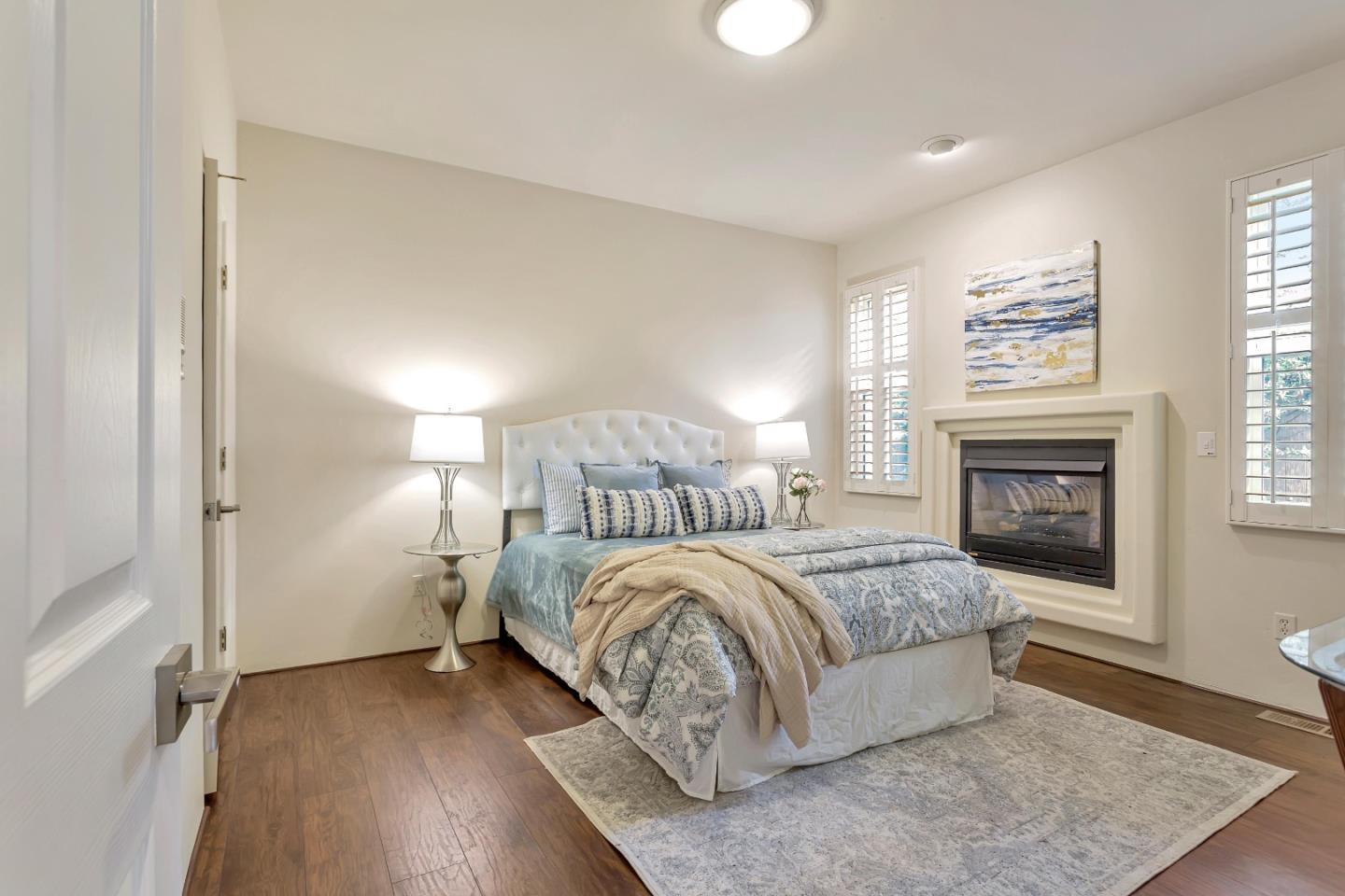 3120 Middle Ranch Road Pebble Beach, CA 93953 - Photo 15 of 39 a spacious bedroom with a bed and a fireplace