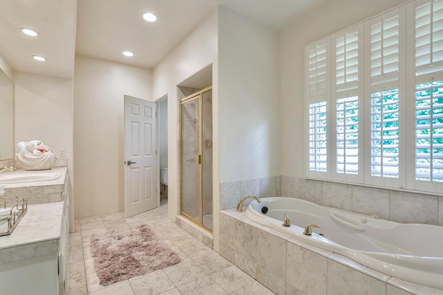 3120 Middle Ranch Road Pebble Beach, CA 93953 - Photo 20 of 39 a bathroom with a tub a window and a shower