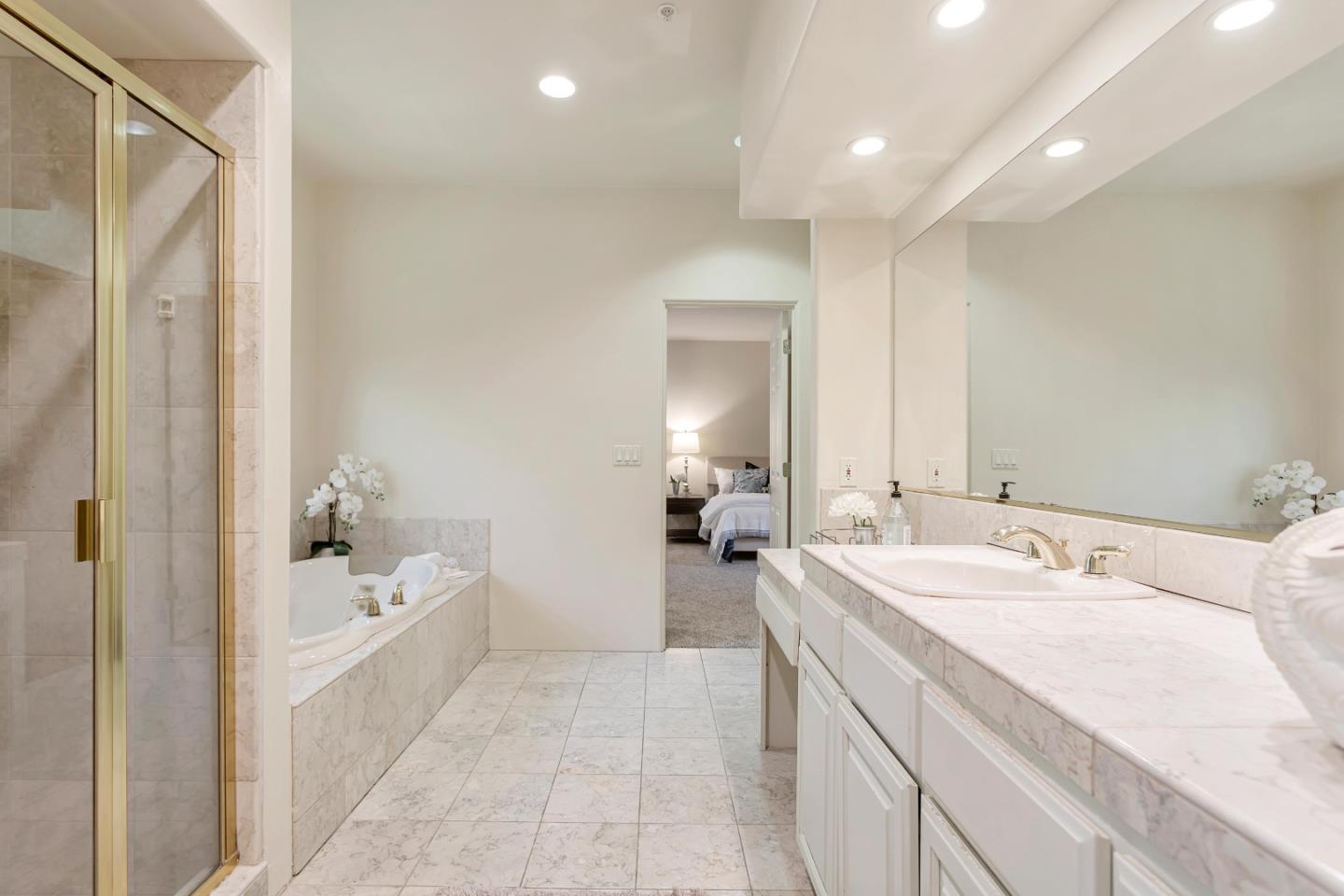 3120 Middle Ranch Road Pebble Beach, CA 93953 - Photo 21 of 39 a spacious bathroom with a bathtub sink and mirror