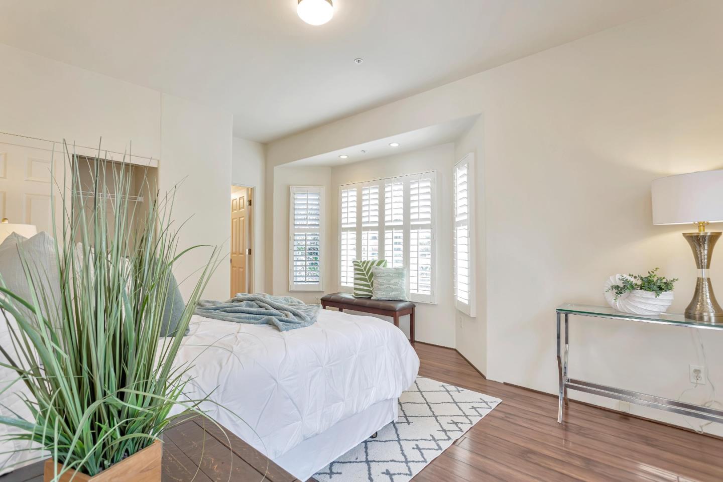 3120 Middle Ranch Road Pebble Beach, CA 93953 - Photo 23 of 39 a spacious bedroom with a bed table and a window