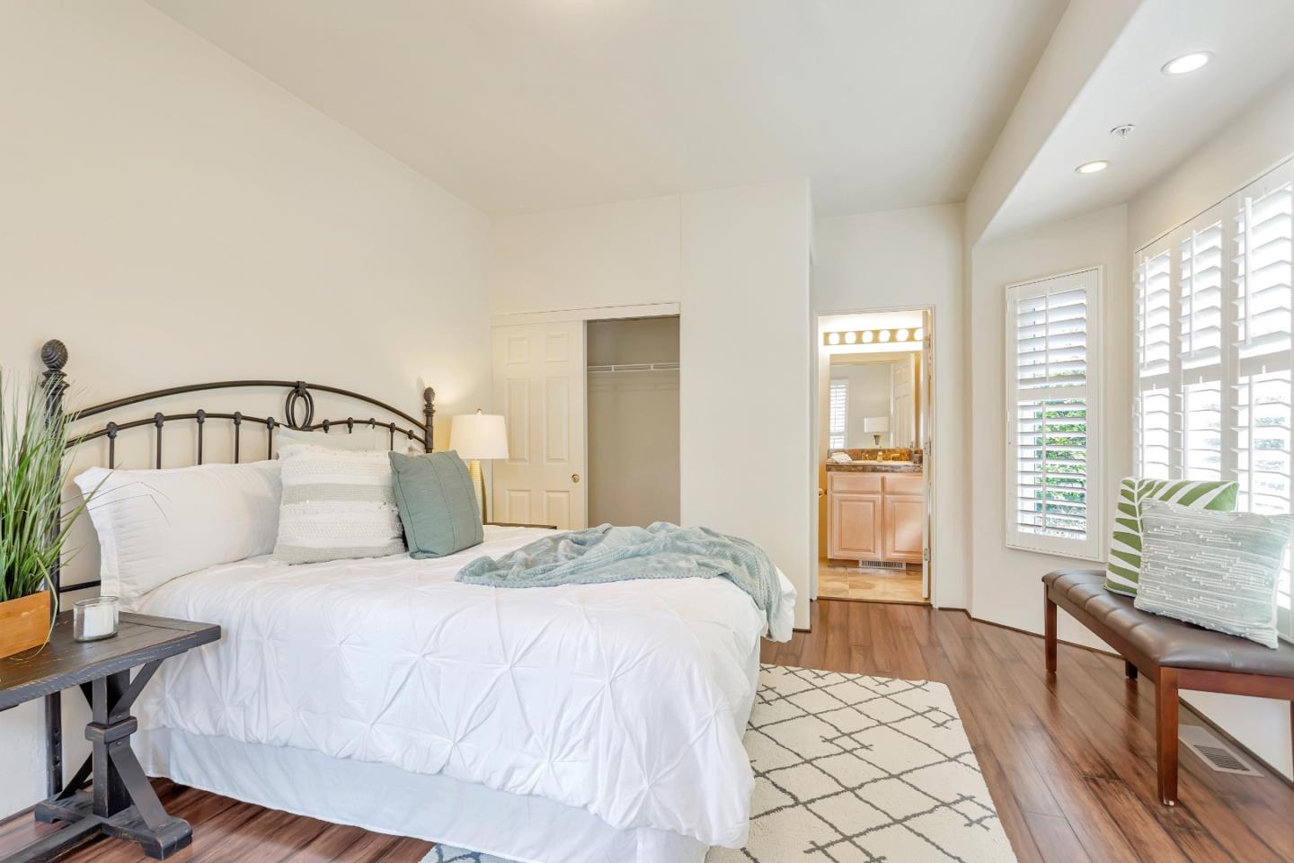3120 Middle Ranch Road Pebble Beach, CA 93953 - Photo 24 of 39 a bedroom with a bed next to a window with table and chair