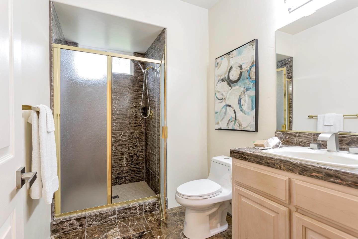 3120 Middle Ranch Road Pebble Beach, CA 93953 - Photo 26 of 39 a bathroom with a granite countertop sink toilet and shower