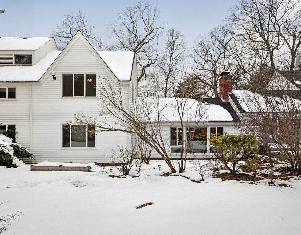 36 Todd Pond Road, Unit 36 Lincoln, MA 01773 - Photo 23 of 26 a view of a white house with a yard covered in snow