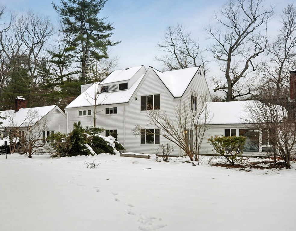 36 Todd Pond Road, Unit 36 Lincoln, MA 01773 - Photo 24 of 26 a front view of a house with a yard covered in snow