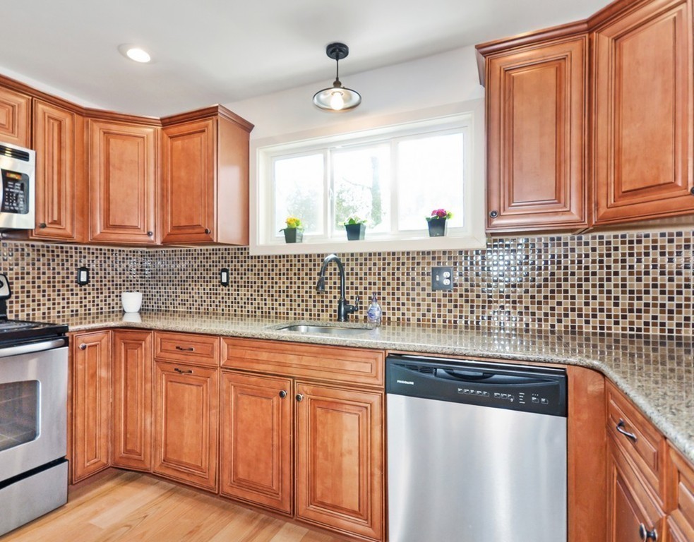 36 Todd Pond Road, Unit 36 Lincoln, MA 01773 - Photo 7 of 26 a kitchen with stainless steel appliances granite countertop a sink stove and cabinets