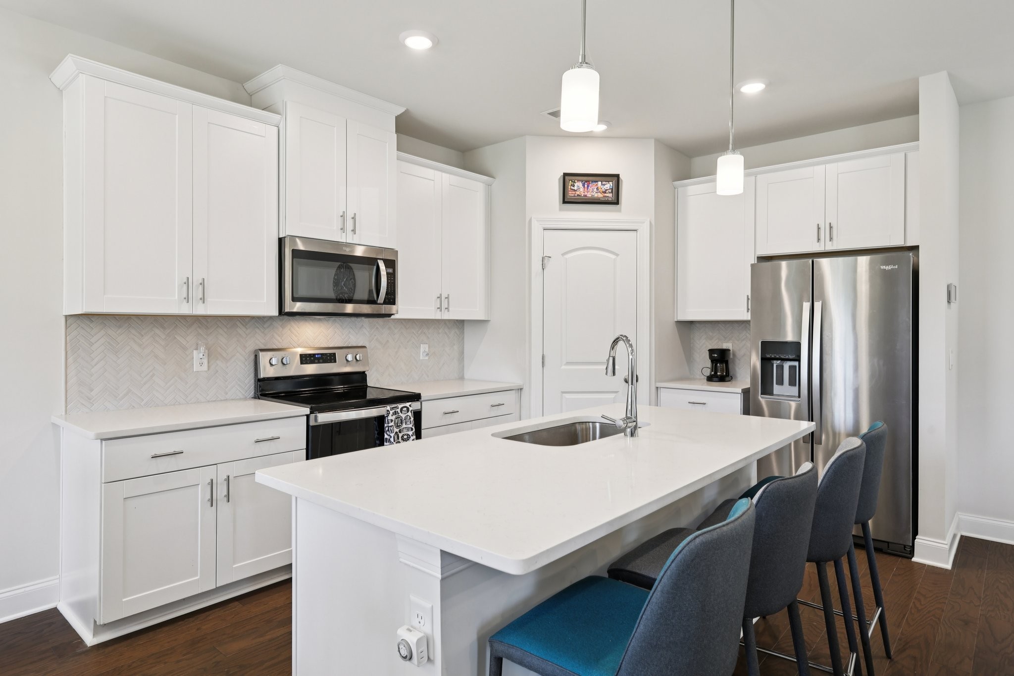 668 Taylor Bend Columbia, TN 38401 - Photo 11 of 35 a kitchen with stainless steel appliances a table chairs refrigerator and microwave